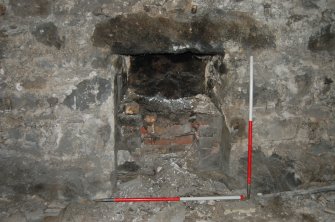 Watching Brief photograph, Existing retail space fronting onto High Street - NW facing elevation stripped back to stonework with S-most hearth close up; with flash, 17-19 High Street, Fraserburgh