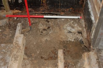 Watching Brief photograph, Trench 3 cleared to required level with base of N wall with metal plate and I beam above granite wall foundation; with flash, 17-19 High Street, Fraserburgh