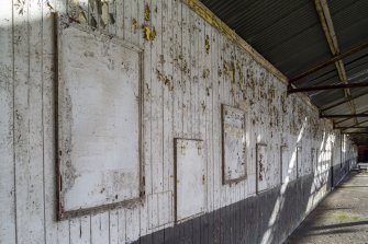 View of back wall of stadium showing closed tote windows.