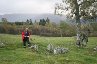 View of chambered cairn being recorded by Mike Middleton (RCAHMS).