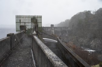 Earlstoun Dam. Walkway and spillway from south looking towards valve house and Earlstoun Loch