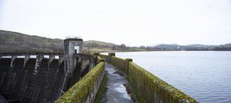 Carsfad Dam. East side of walkway, outlet needle valve house on extreme left