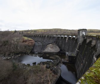 Carsfad Dam. View from east of dam, spillway and outlet needle valve house (right)
