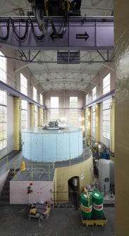 Interior. Carsfad Hydro Electric Power Station. Turbine House. View of one of the 6000Kw generator sets, its turbine sits below the set at basement level. Electrical current is generated under the light blue casing.