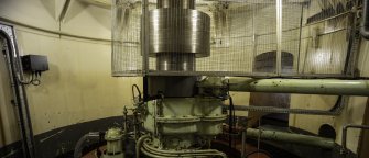 Interior. Carsfad Hydro Electric Power Station. Turbine/Power House. Shaft running from turbine below to rotor above in generator set