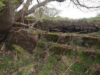 View of the foundations on the E showing the concrete floor above the stone wall close to the building’s NE corner