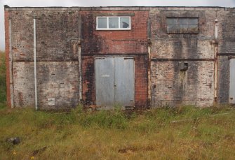 Explosives Magazine R53: the restoration of two brickwork panels around a window and a double door