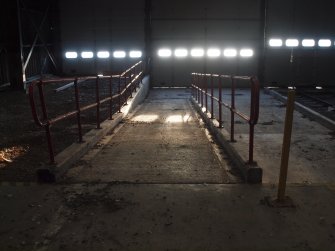 View of the ramp at the WSW end of the platform within the main transit building (Y17), with the former course of the Narrow Gauge Railway (left) and the Standard Gauge track (right)