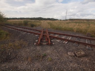 View from the NNW of the three concrete slabs in the tarmac to the SW of the office and the electricity sub-station