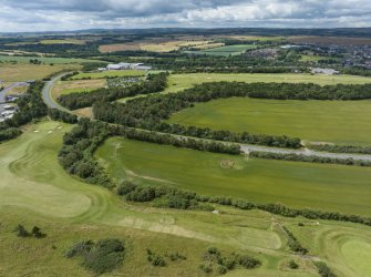 Oblique aerial view from north-east showing Recreation (Golf Course) and area for proposed development in Modern (Gunsgreenhill) Areas of Townscape Character, Eyemouth