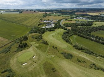 Oblique aerial view from north-east showing Recreation (Golf Course) and Industrial (Gunsgreenhill Industrial Estate) Areas of Townscape Character, Eyemouth