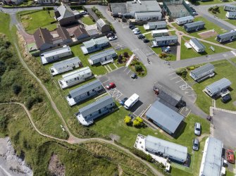 Oblique aerial view from east-north-east showing Recreation (Holiday Park) and Mid- to Late C20 (Barefoots) Areas of Townscape Character, Eyemouth