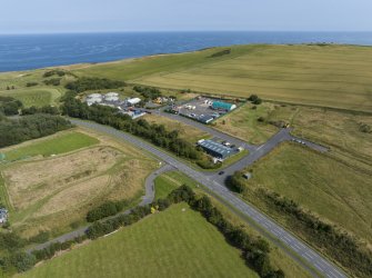 Oblique aerial view from north-west showing Industrial (Gunsgreenhill Industrial Estate) and Recreation (Golf Course) Areas of Townscape Character, Eyemouth