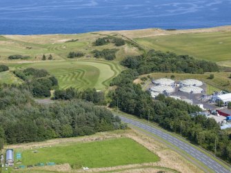 Oblique aerial view from west showing Industrial (Gunsgreenhill Industrial Estate) and Recreation (Golf Course) Areas of Townscape Character, Eyemouth