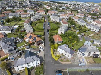 Oblique aerial view from south showing Inter-War (Hurkur Crescent and Schools) Area of Townscape Character, Eyemouth