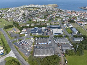 Oblique aerial view from south-south-west showing Industrial (Acredale and Eyemouth Industrial Estates) and Inter-War (Hurkur Crescent and Schools) Areas of Townscape Character, Eyemouth