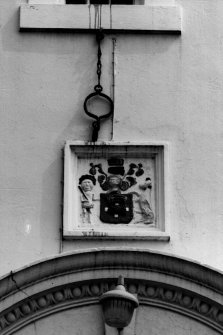 Detail of jougs and heraldic plaque over N elevation doorway.