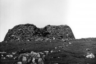 View looking upslope from the SE towards the external wall of the broch.