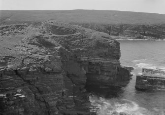 View across cliffs to the Broch of Borwick.

Glass negative.