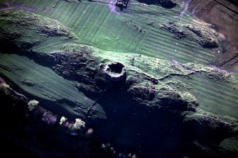 Oblique aerial view centred on the remains of the broch, taken from the E.