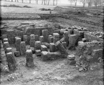 Excavation photograph. Hypocaust pillars beneath room 15 of Praetorium.


Duplicate print (C 30084) from A O Curle album (MS/28/461) is titled
'Western Hypocaust from SE'.