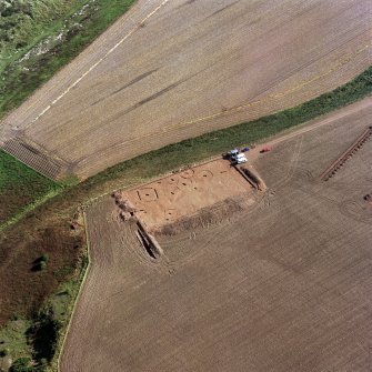 Oblique aerial view of Red Castle centred on the excavations of a barrow cemetery, taken from the WNW.