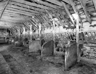 View of interior of byre from W end, byre located in E end of S range