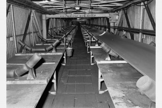 View inside the conveyor gantry containing two belt-conveyors (one with belt removed) carrying coal to the preparation plant (conveyor belt 1.3m wide), Seafield Colliery