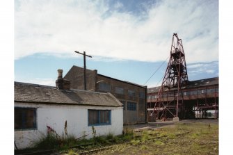 Tool store (left) and rest room, winding engine house (centre) and headstock, viewed from North East.