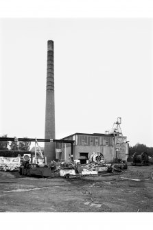 General view from SW of Boilerhouse, ash hopper and chimney stalk.