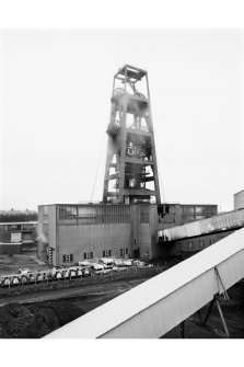 General view from SW of no. 1 shaft headframe, and two ground-mounted winding-engine houses.