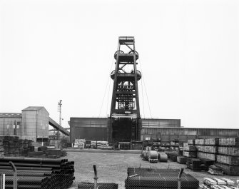 General view from NNE of no. 1 shaft headframe, and two ground-mounted winding-houses.