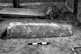 View from side of coped grave marker.