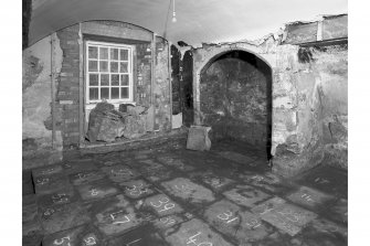 View from North East showing exposed chamfered fireplace and numbered flags, room 6