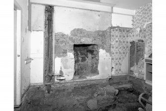 View from North West showing original floor level and exposed fireplace, room 9