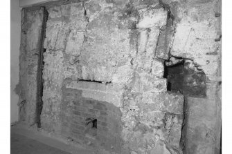 View from South West showing blocked opening and blocked fireplace, room 16