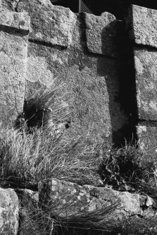 Detail of parapet showing flagstone with drainage outlet.