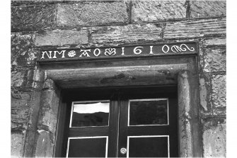 Detail of lintel inscribed 'NM AO 1610' above door of Moncrief House, High Street, Falkland