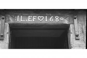 Detail of carved marriage lintel above the entrance to the Mill Wynd wing of the Stag Inn, inscribed 'IL.EF 1680', Falkland.