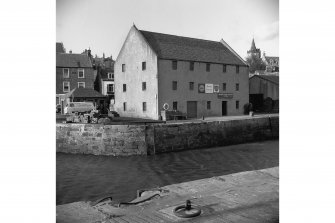 View of old store-house at angle between old and new basins, showing contrast in masonry types on respective quay walls