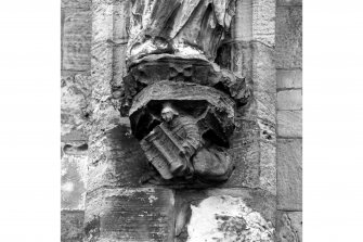 Detail showing a corbel with a carved angel holding 'arma Christi' emblem; South front, South range