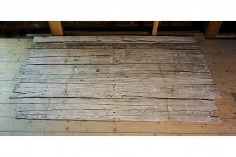 View of painted planks from ceiling of chapel vestibule.