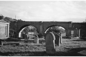 View of arches with gravestones in foreground
