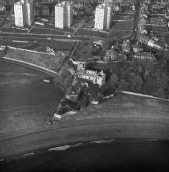 Oblique aerial view from South East of Ravenscraig Castle. Includes Pathhead tower blocks.