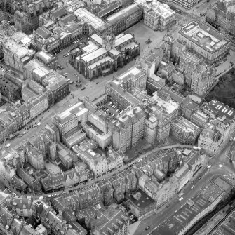 Oblique aerial view showing High Street between North Bridge and Lawnmarket with Cockburn Street at bottom of photo, City Chambers in centre and St Giles' Cathedral at top