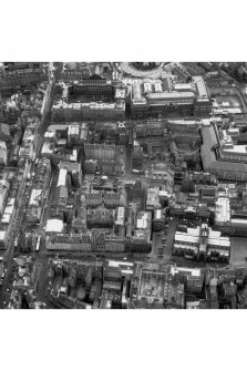 Oblique aerial view of centre of Edinburgh including South Bridge to left of photograph, Old College and Royal Museum of Scotland at top, Parliament Square, High Court to right and City Chambers at bottom