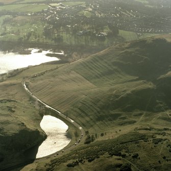 Oblique aerial view of Holyrood Park centred on the remains of cultivation terraces and rig, taken from the NNE.