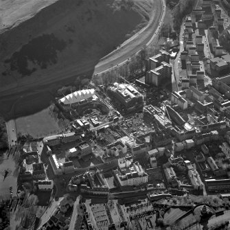 Oblique aerial view centred on the Scottish parliament under construction with 'Our Dynamic Earth' adjacent, taken from the NNE.