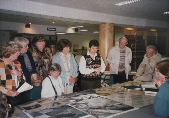 Commission at Work.
Lesley Ferguson showing visitors examples from the collections in the NMRS library.