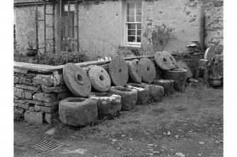 Westray, Pierowall, Quern Stones and Knocking Stones
View from NNE showing collection of quern stones and knocking stones with main entrance to Rose Cottage in background